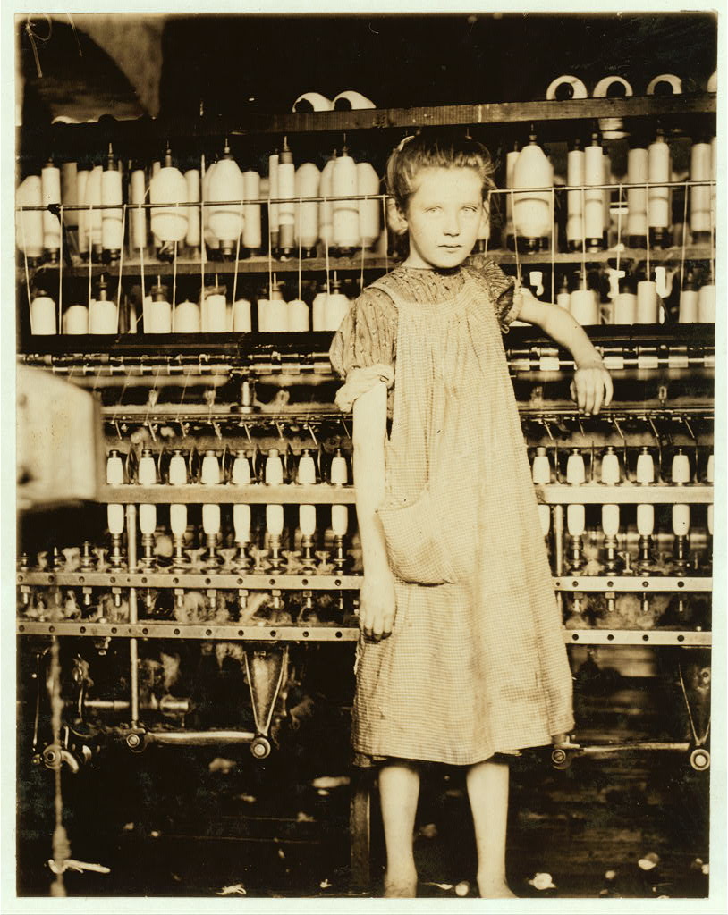 black and white photo of young girl of about 11 in a factory setting