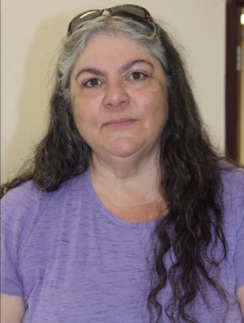 Woman with Grey and Black hair and purple Shirt