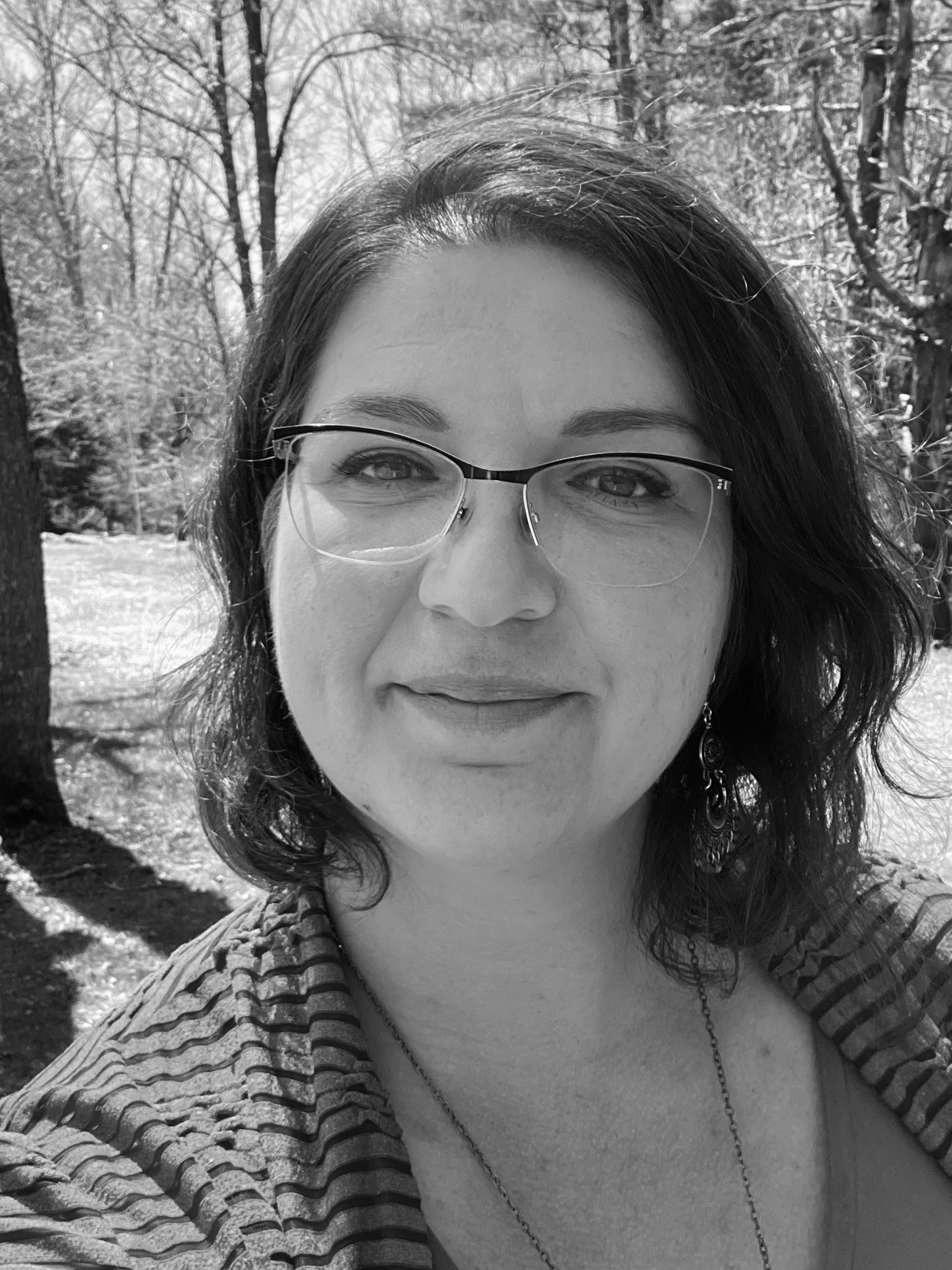 black & white photo of white female with glasses and nice smile