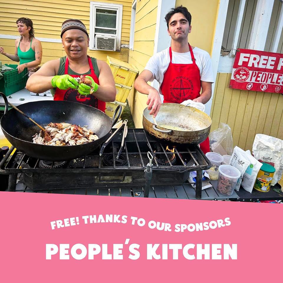 People at a table smiling and serving food