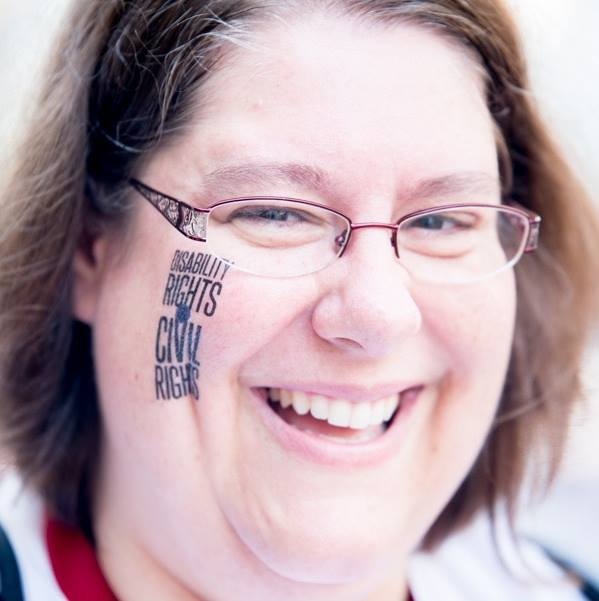 white female brown hair and glasses with Disability Rights and Civil Rights stamped on face