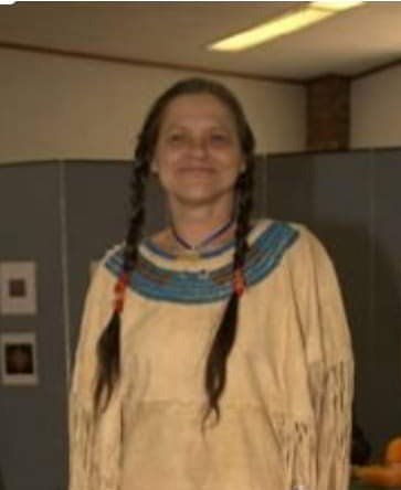 Native American woman in Native garb.  long dark braids